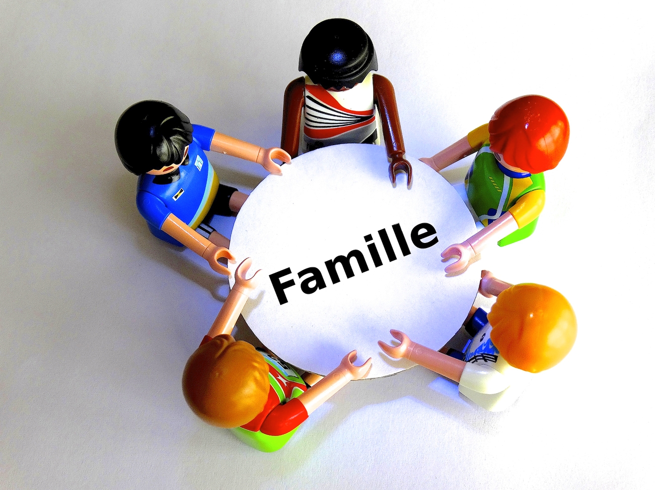 Des figurines représentant les membres d'une famille réunie autour d'une table pour mieux communiquer